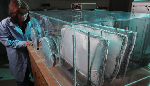 Woman in lab coat overseeing custom product development of materials