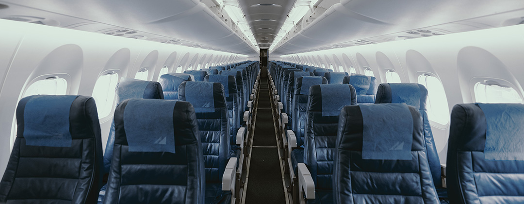 Prespective of the interrior of an airplane with blue seats and flooring