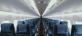 Prespective of the interrior of an airplane with blue seats and flooring