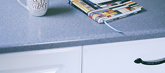 Blue countertop with notebook and coffee mug