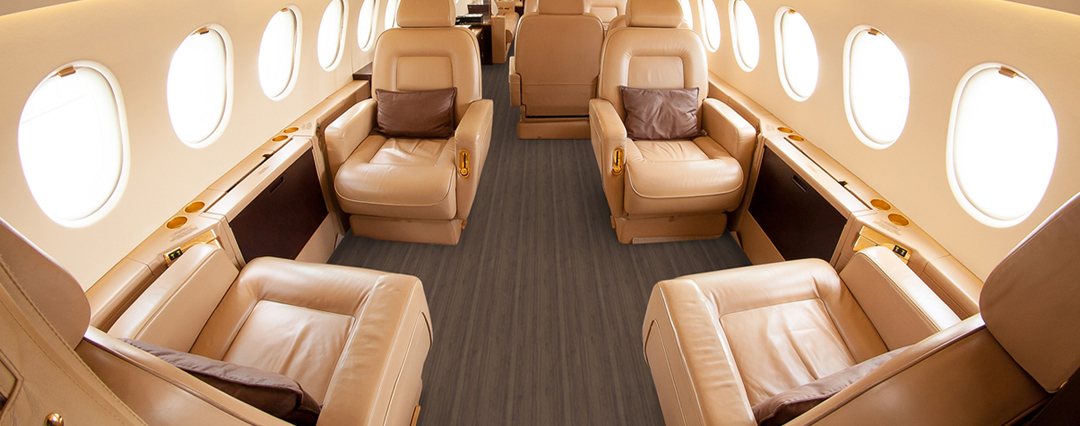 Interior of an airplane with tan wood like non-textile flooring near exit